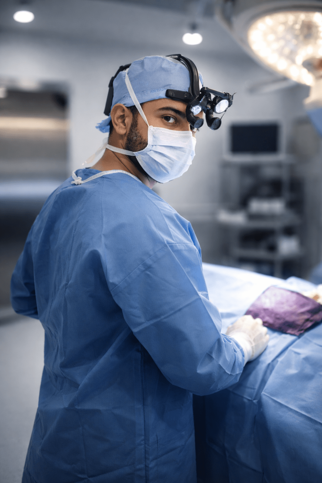 Surgical Precision: Dr. Dalati utilizing 3.5x magnification loupes for sub-millimeter revision rhinoplasty repair.